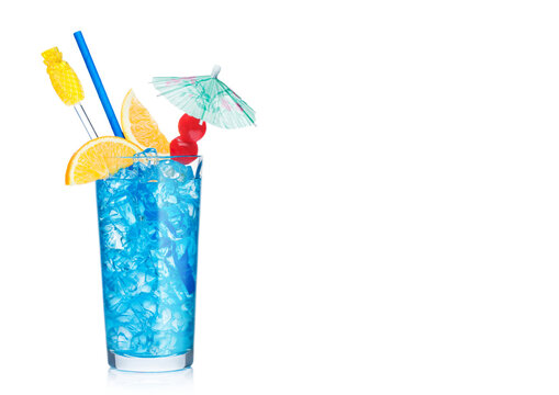 Blue lagoon cocktail highball glass with straw,stirrer and orange slice with sweet cherry and umbrella on white. Vodka and blue curacao liqueur mix.