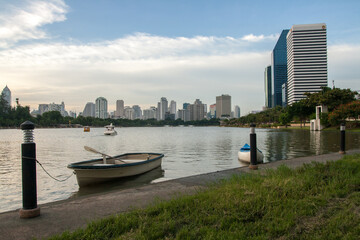 Fototapeta premium Bangkok Skyscraper with boat in the garden, Thailand