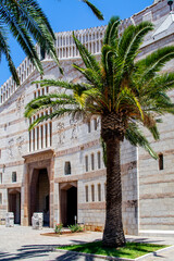 Nazareth, Israel. June 26, 2020: The Basilica of the Annunciation, built over the house of the Virgin Mary in 1969. It is white with horizontal light pink stripes.