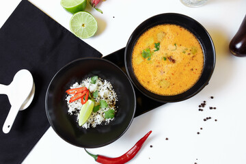 Tom Kha. Spicy spicy Asian soup with eggplant, chicken, mushrooms, lemongrass, served with rice and cilantro