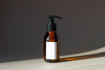 Amber glass pump bottle mockup with natural organic shampoo or hand gel soap. Beauty product...