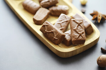 Chocolate bars on a black background in backlight. Chocolate with filling. Sweet sweets for snack and tea.