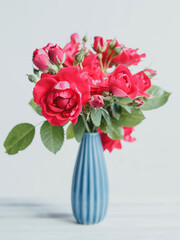 Bouquet of red roses in a blue vase