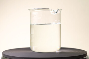 glass with a clear liquid. Chemical experiments in the laborator