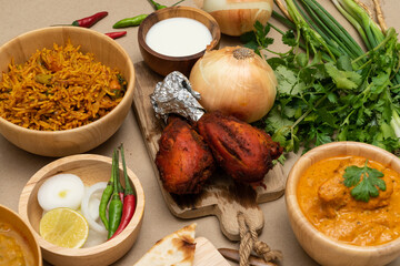 Various indian food menus, biryani rice, butter chicken, tandoori, bean curry and naan bread