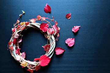 Autumn background with vibrant fall leaves on black, a design template with a place for text