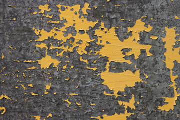 The texture of sheet metal with peeling yellow paint. Material for the design, old iron surface, metal background.