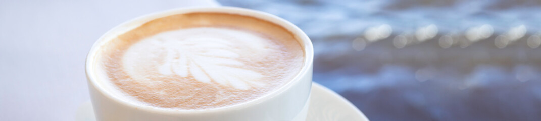 white cup with art coffee