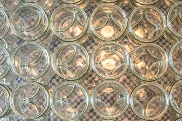 many glass jar empty glasses row for jam honey with lid caps abstract background bokeh
