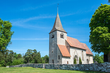 Fototapeta na wymiar Bro church is a medieval countryside church on Swedish Baltic sea island Gotland dating back to the 12th century. Gotland is famous for its many medieval countryside churches.