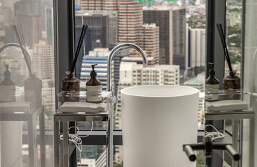 Modern hygienic hand basin with cityscape that can look outside from big window. Elegant faucets and components, Sanitary ware, The concept of health care. Selective focus.