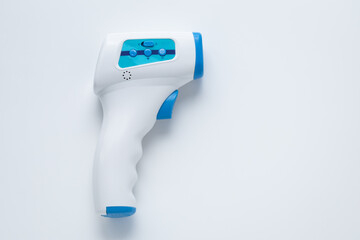 Non-contact infrared digital thermometer on a white background. Mockup with copy space. A tool for...