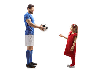 Football player giving a soccer ball to a little girl