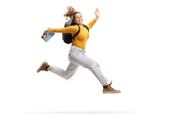 Fototapeta na wymiar Female student holding a book and jumping high