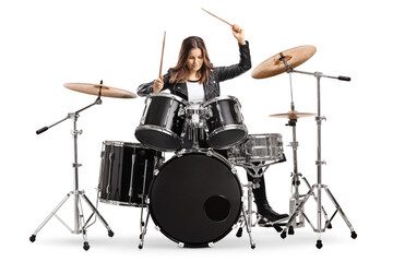 Young female drummer playing drums with drumsticks