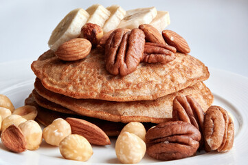 Pancakes with nuts and sliced bananas