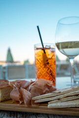 Close up of a tall glass of italian Spritz, famous cocktail with sparkling wine an orange flavored...