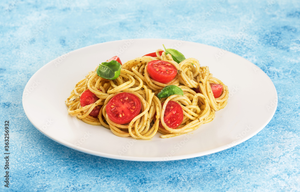 Wall mural pasta with pesto sauce, tomatoes and basil.