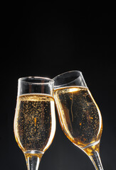 Glass full of champagne on black background