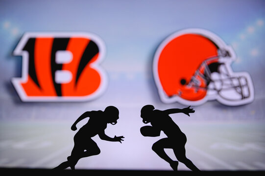 Cincinnati Bengals vs. Cleveland Browns. NFL match poster. Two american football players silhouette facing each other on the field. Clubs logo in background. Rivalry concept photo.