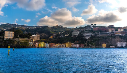Fototapeta na wymiar Sailing towards the old harbour at Marina Grande in Sorrento, Italy on a bright spring evening