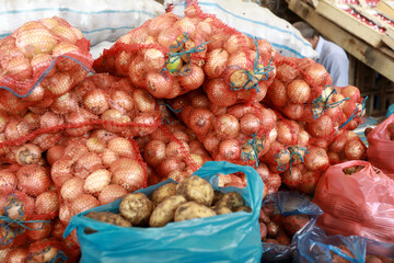 Bags with onions in market