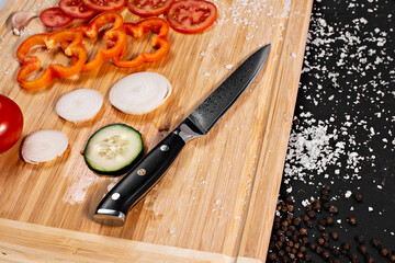 Closeup of hands of chef cook cutting vegetables on wooden table