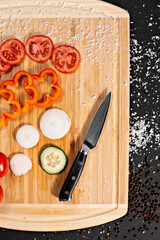 Closeup of hands of chef cook cutting vegetables on wooden table
