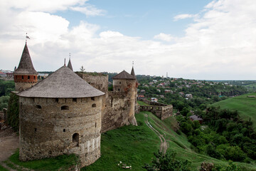 Fototapeta na wymiar Medieval stone fortress with towers and walls, Kamenets Podolski in Ukraine. Protective fort, impregnable fortress, protective structure.