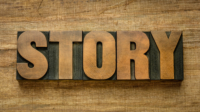 story word abstract in vintage letterpress wood type against handmade banana paper, news and narrative concept