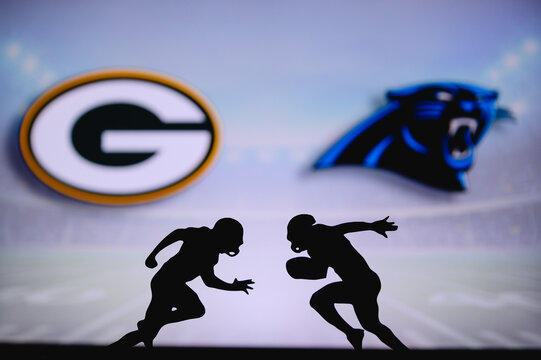Green Bay Packers vs. Carolina Panthers. NFL match poster. Two american football players silhouette facing each other on the field. Clubs logo in background. Rivalry concept photo.
