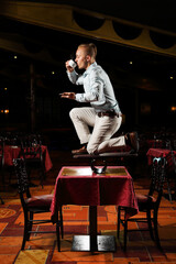 circus performer drink coffee in restaurant