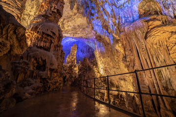 Fototapeta na wymiar Postojna Cave in Slovenia iluminated with blue lighs