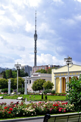 Naklejka premium Moscow, Russia - July 2, 2020: View of Ostankino Tower from VDNKh park. Moscow TV tower against the overcast sky
