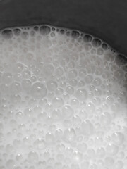 White bubbles of boiling milk.
