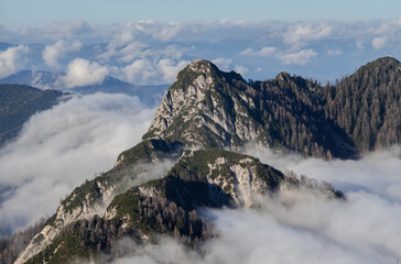 Fototapeta na wymiar Mountain surrounded by low clouds