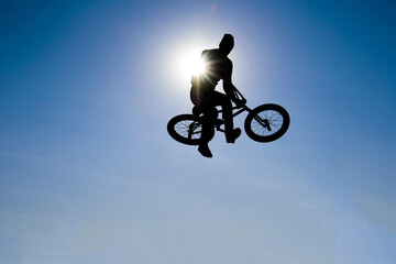 Silhouette  of bicyclist against the background of the sky.
