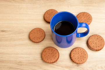 Good morning with coffee. A cup of coffee in blue. Biscuits. . Sunny.