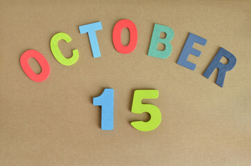 October 15, Toy alphabet with a brown background.
