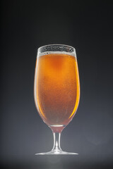 Glass of beer on black background, copy space