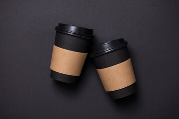Black take away coffee cup with blank brown paper label