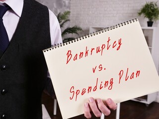Financial concept meaning Bankruptcy Vs. Spending Plan with phrase on the sheet.
