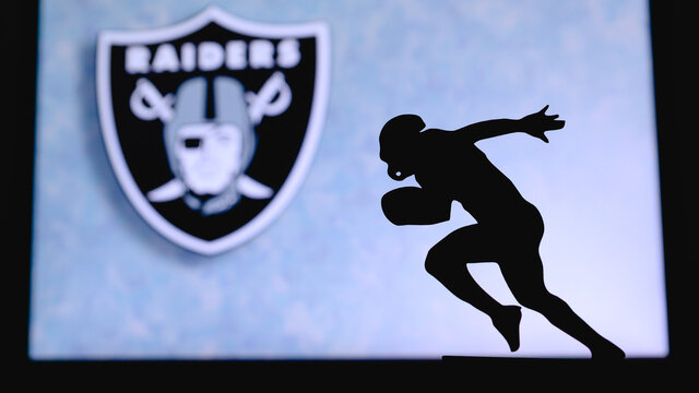 Las Vegas Raiders. Silhouette Of Professional American Football Player. Logo Of NFL Club In Background, Edit Space.