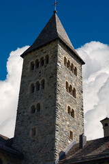 Fototapeta na wymiar Herz-Jesu-Kirche, Church of the Sacred Heart (1911) in Romanesque style in the small village of Samedan, tourist resort in Engadin valley, Graubunden canton, Maloja region, Switzerland, Europe 