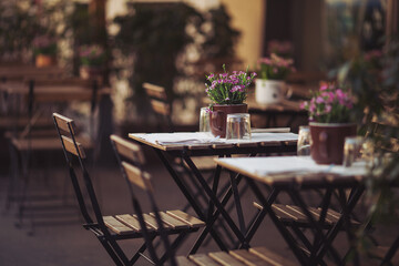 Street view of a coffee terrace with tables and chairs in europe