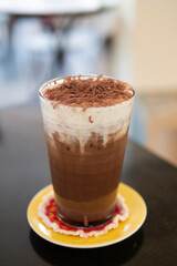 iced cocoa chocolate drink with cream foam topped with cocao powder cold drink beverage at cafe for refresh
