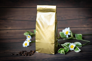 Coffee pouch mockup with croissant and milk in beans on dark romantic blue background. Gold paper clear bag