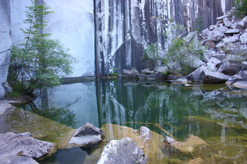 small natural lake inside a marble quarry