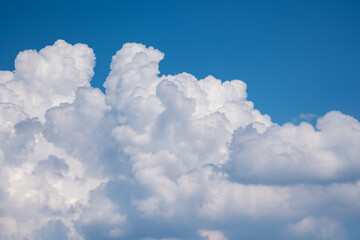 Naklejka na ściany i meble White cumulus beautiful clouds float in the blue sky.