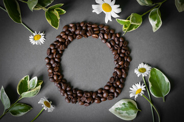 Heart made of coffee beans in chamomile flowers on a gray blue background mockup pouch with croissant and milk in beans on dark romantic Gold paper clear bag